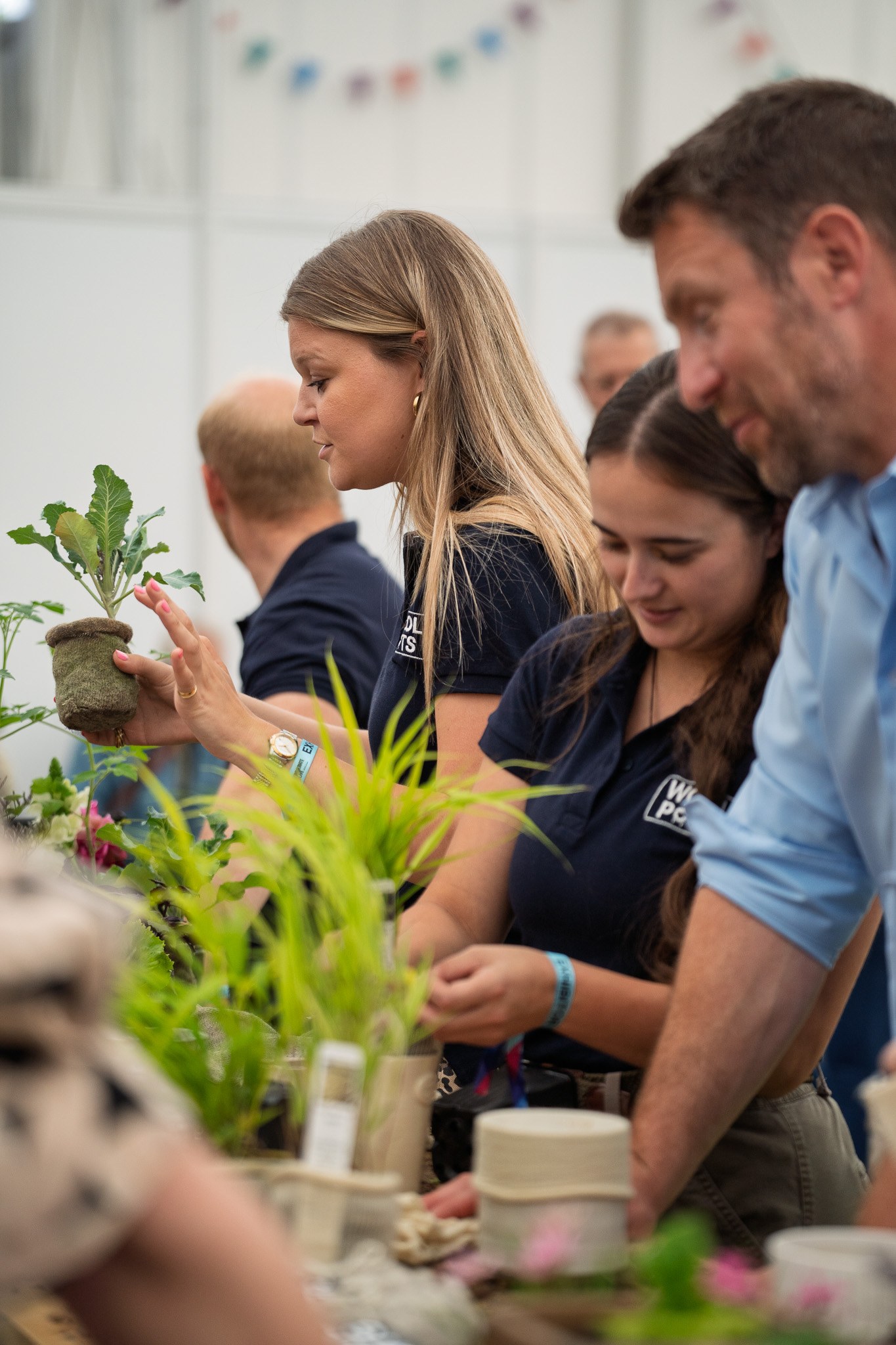 A group of people taking part in a practical planting workshop.