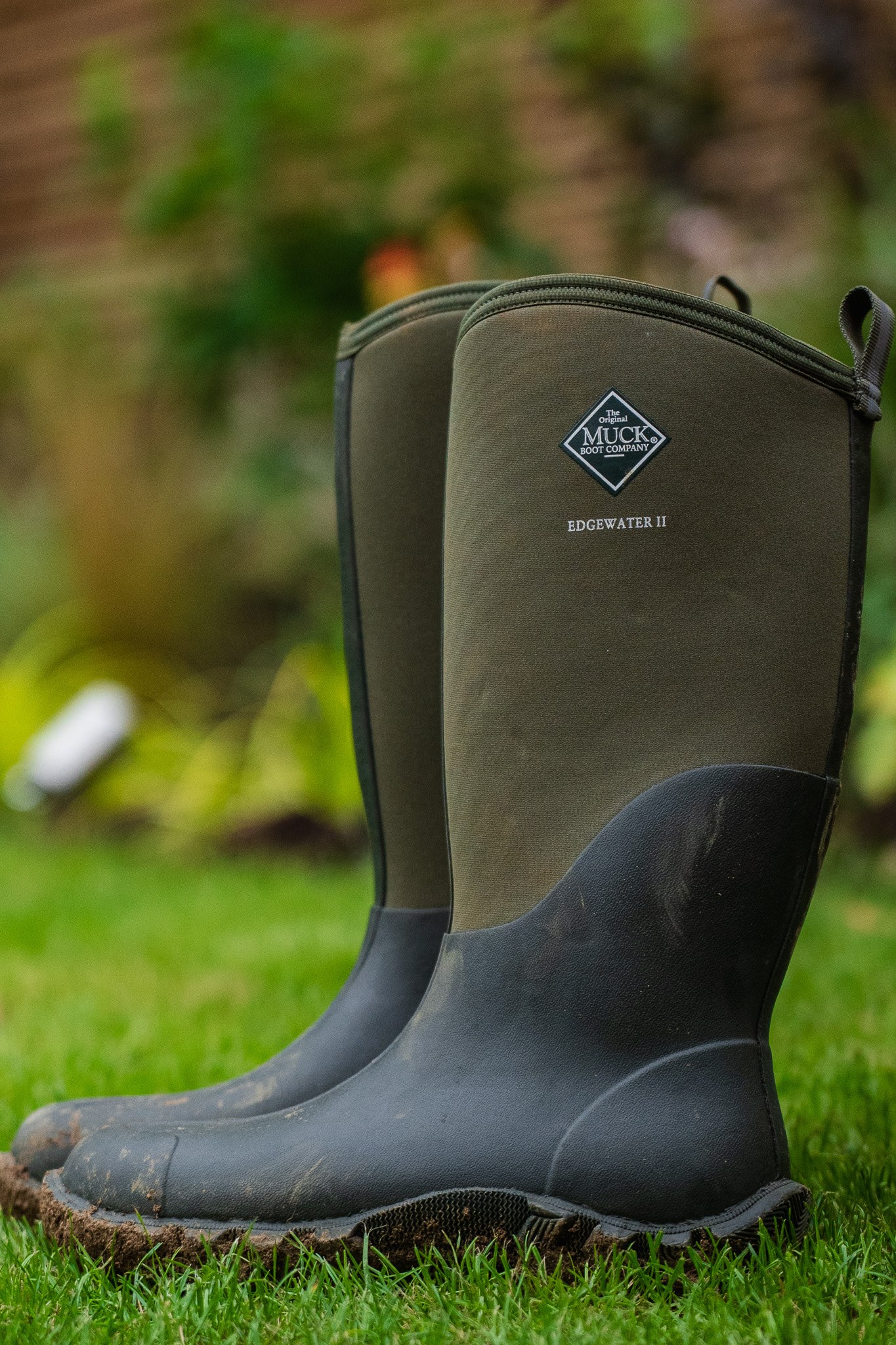 Green Muck Boot wellington boots photographed on grass.